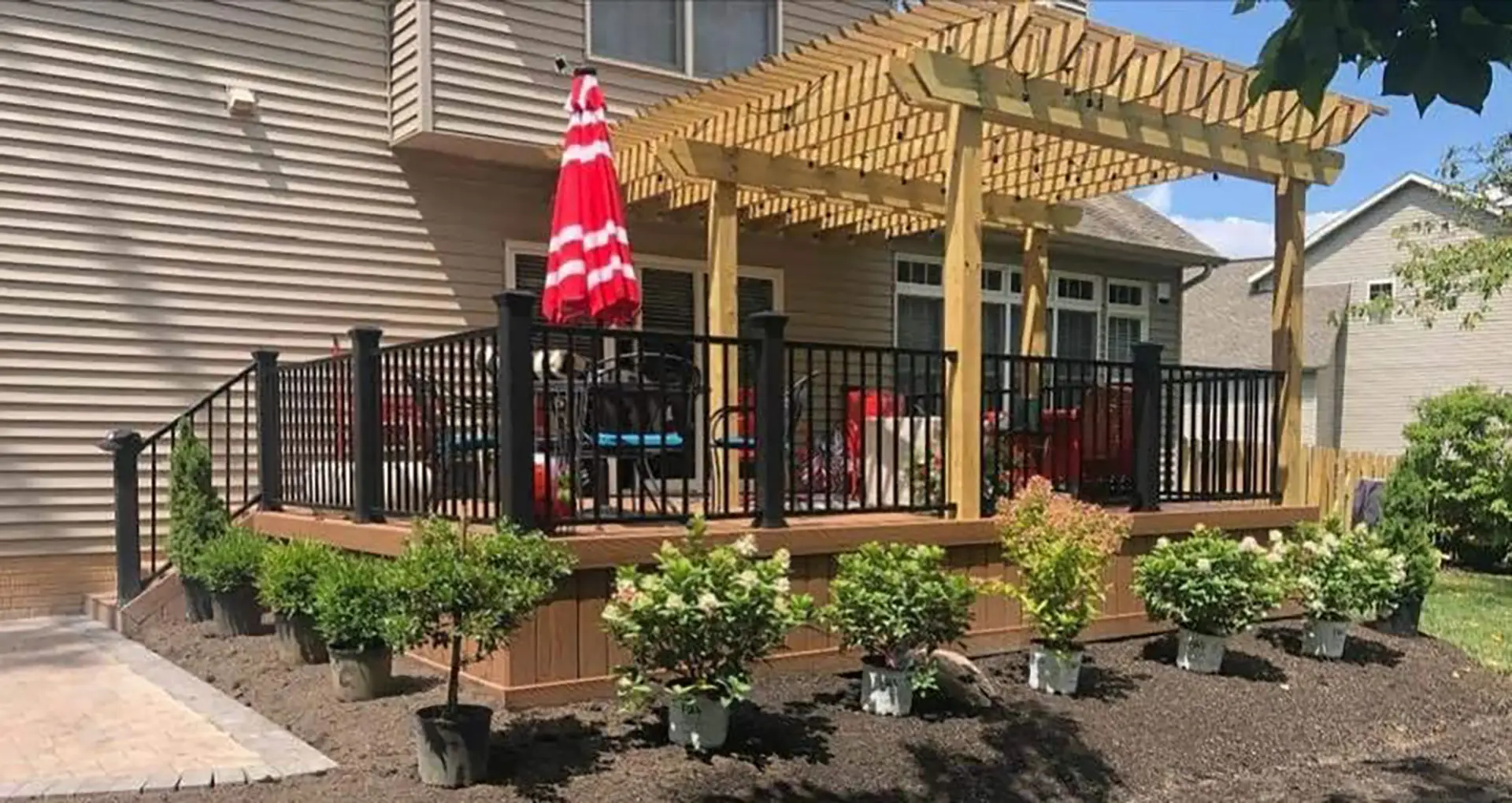 Photo of a raised deck with traditional wooden pergola.